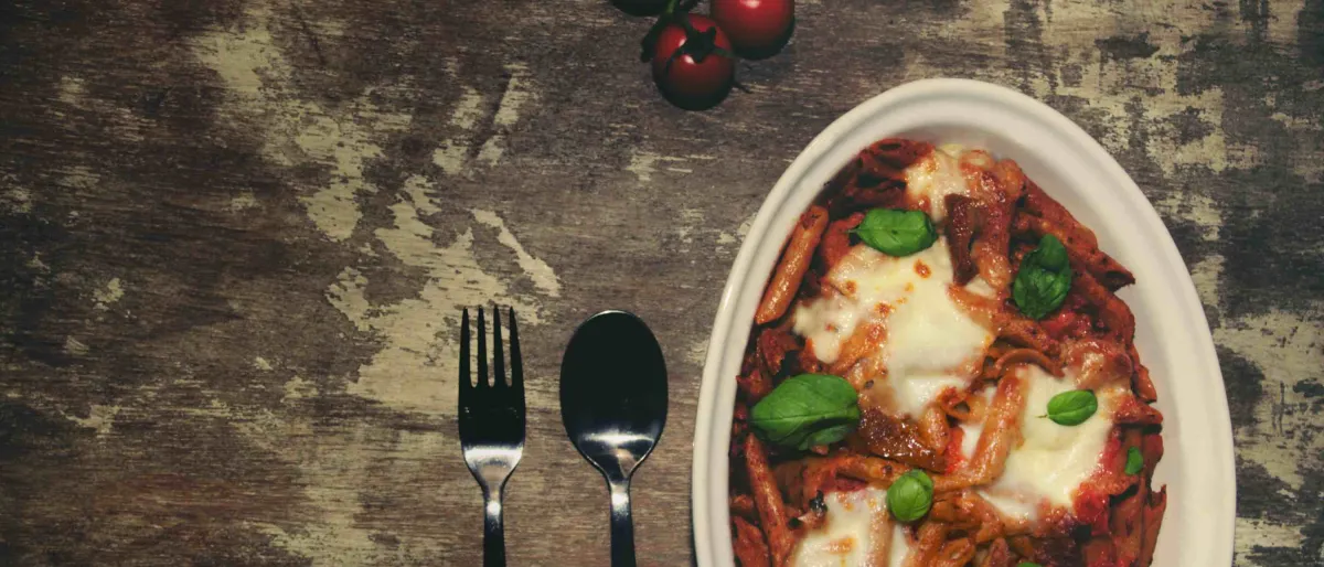 Mouth watering vegetarian pasta bake with rich tomato sauce and cheese toppings